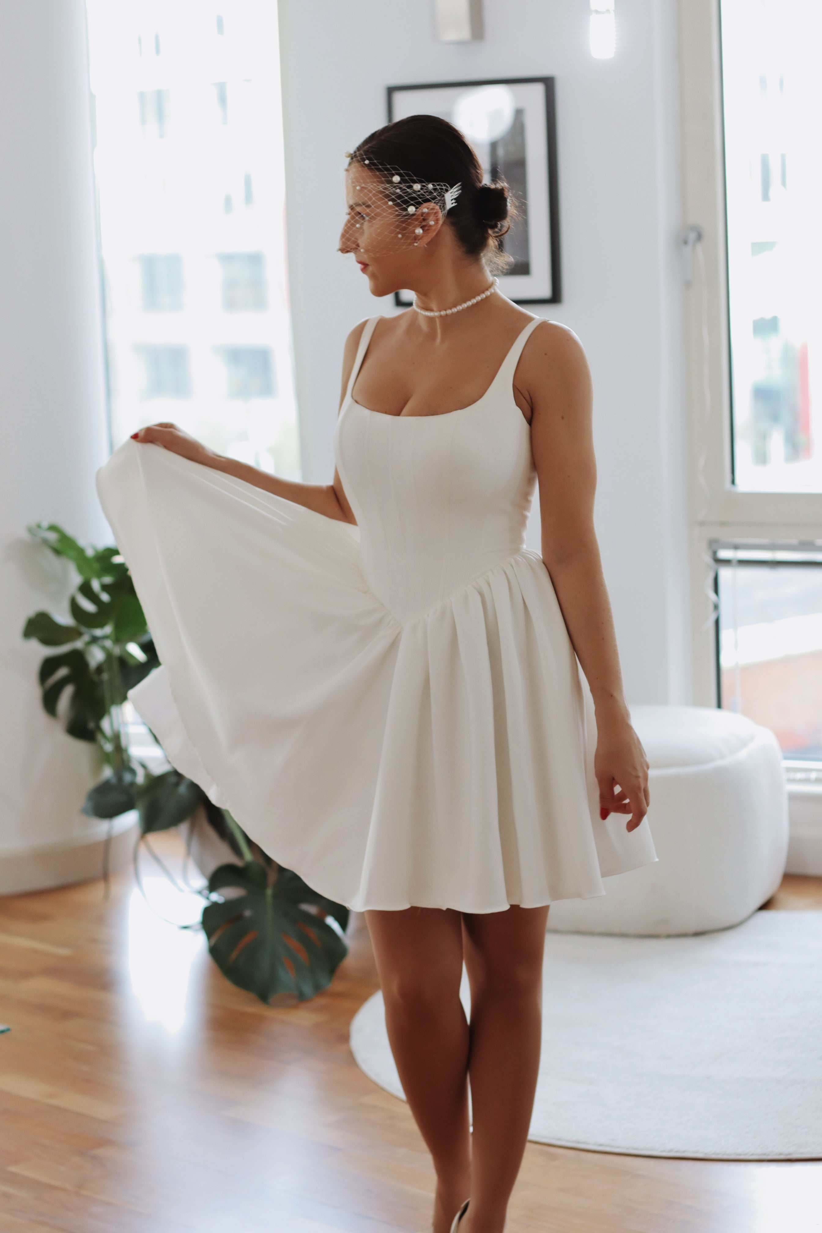 Introducing Mini Hope – the latest addition to our luxury crepe wedding dress collection, now in an elegant mini version. This chic basque waist bridal gown reimagines a classic trend, offering the same signature V-shaped waistline that’s captivating brides, but with a playful, contemporary twist. Designed to exude charm and sophistication, the Mini Hope is perfect for brides seeking a refined yet modern statement.