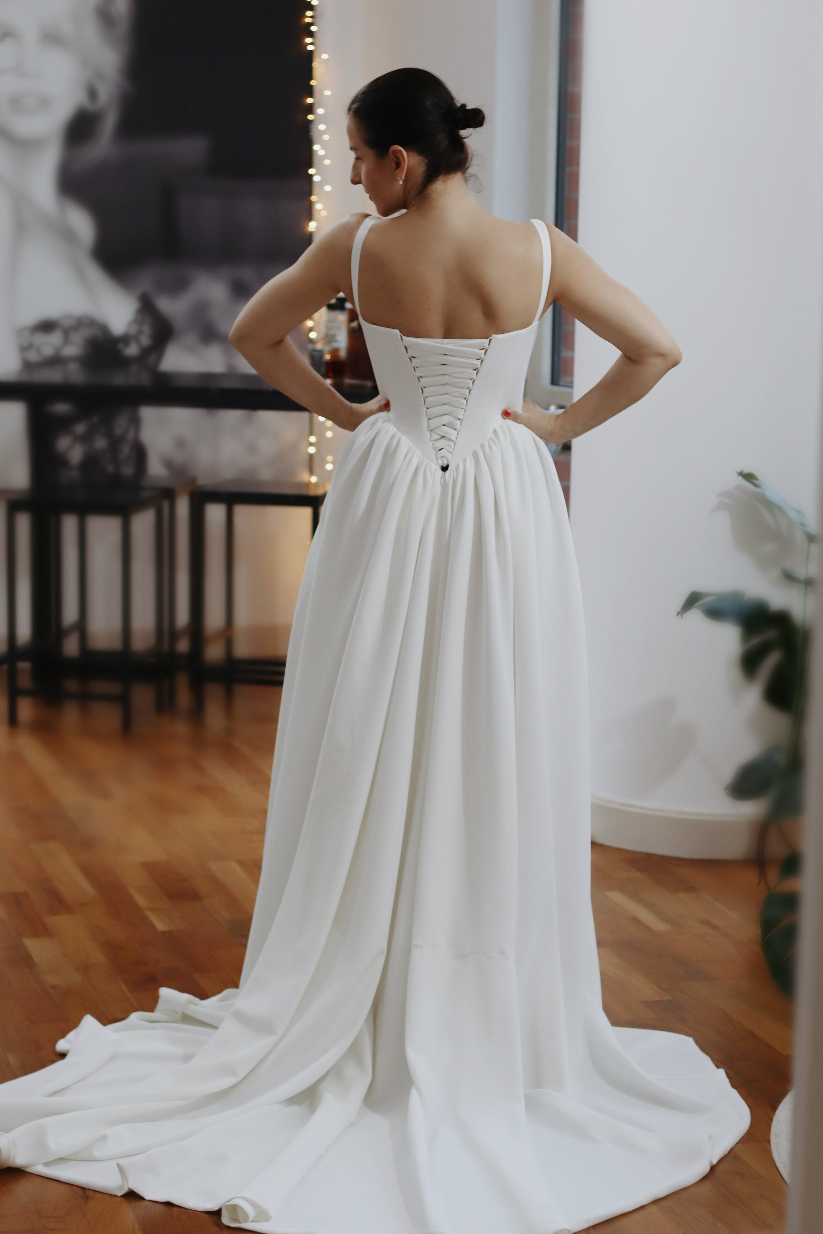 Introducing Hope - a newest addition to our luxury crepe wedding dress collection.  Basque waist wedding dresses are leading the bridal fashion trends this year, with their signature V-shaped waistline captivating brides everywhere. Our luxury crepe basque waist bridal gown beautifully blends timeless charm with contemporary elegance, designed to make any bride feel exquisite. Crafted from premium crepe fabric, this gown offers a smooth, graceful drape that complements its striking silhouette.