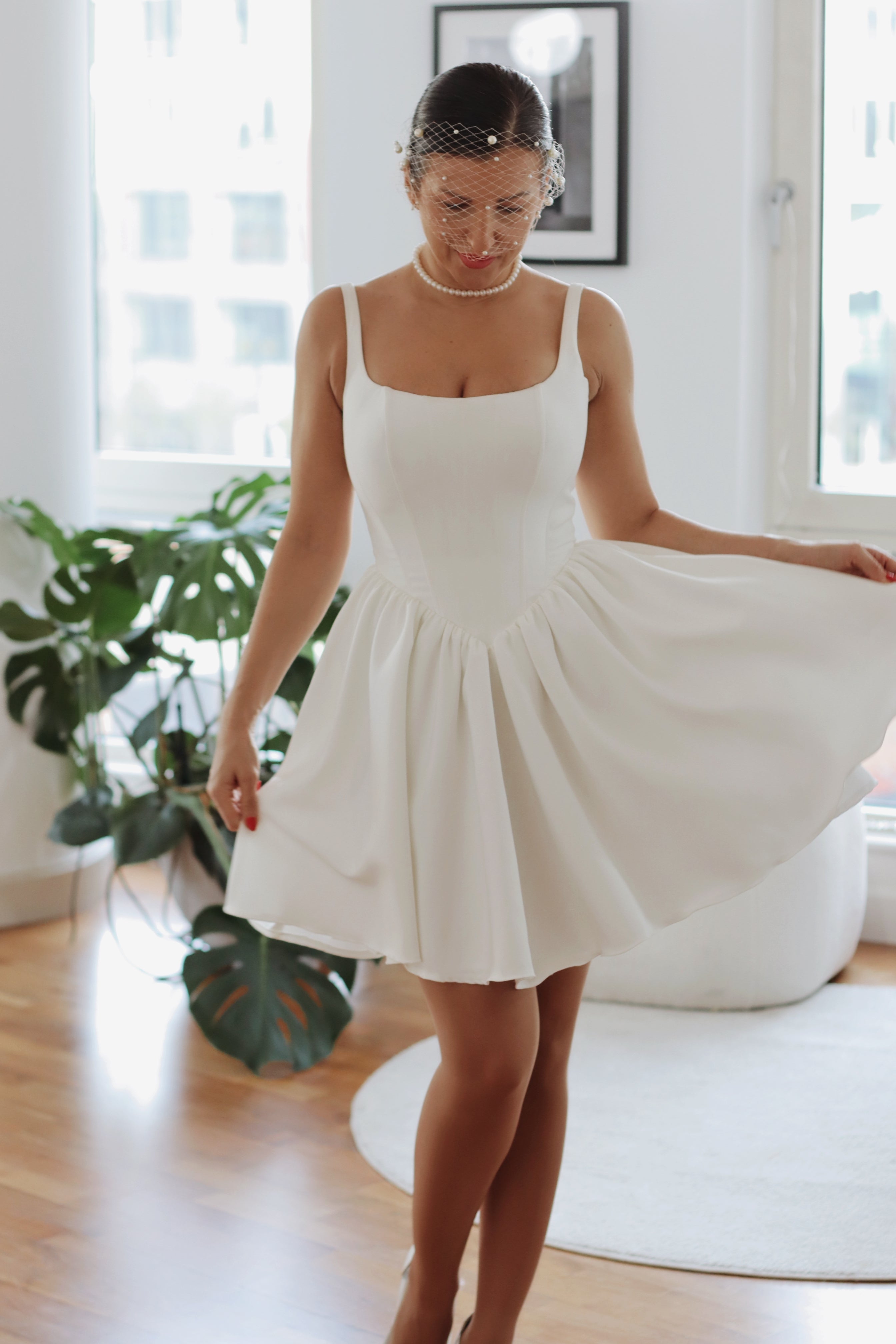 Introducing Mini Hope – the latest addition to our luxury crepe wedding dress collection, now in an elegant mini version. This chic basque waist bridal gown reimagines a classic trend, offering the same signature V-shaped waistline that’s captivating brides, but with a playful, contemporary twist. Designed to exude charm and sophistication, the Mini Hope is perfect for brides seeking a refined yet modern statement.