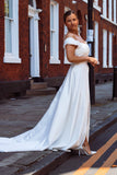 A young bride wearing Velo Bianco minimalistic off the shoulder satin wedding dress with buttoned back paired with short elegant wedding veil and white bridal heels. Manchester City hall wedding outfit for the modern bride.