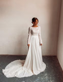 A bride wearing a two piece bohemian lace wedding dress. The ivory lace top is long sleeve and the chiffon skirt is high waisted. This two piece lace dress is perfect for boho themed weddings, rustic weddings and elopements.