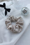 arge silver sequin scrunchie, the perfect accessory for adding a touch of luxury and sparkle to any festive outfit. Handmade with care, its oversized design creates a voluminous, glamorous effect, making it ideal for dressing up your hair for Christmas dinners, New Year’s Eve celebrations, or any special occasion.