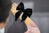 Large black velvet bow with pearl hair tie. Perfect holiday gift for a bride to be and a fashionista. Ideal Christmas Gift made from soft velvet. 