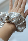 arge silver sequin scrunchie, the perfect accessory for adding a touch of luxury and sparkle to any festive outfit. Handmade with care, its oversized design creates a voluminous, glamorous effect, making it ideal for dressing up your hair for Christmas dinners, New Year’s Eve celebrations, or any special occasion.