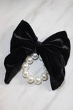 Large black velvet bow with pearl hair tie. Perfect holiday gift for a bride to be and a fashionista. Ideal Christmas Gift made from soft velvet. 