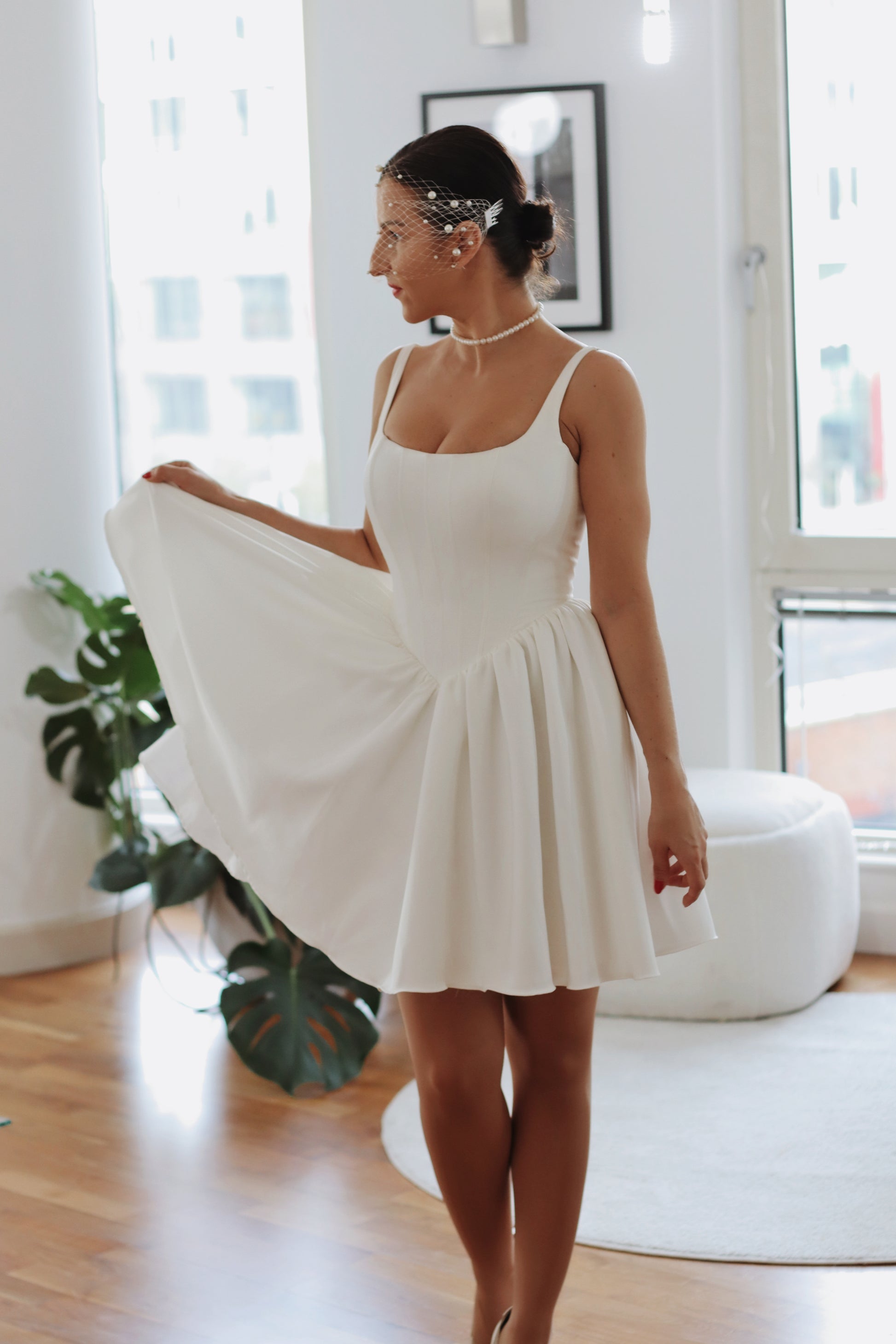 Introducing Mini Hope – the latest addition to our luxury crepe wedding dress collection, now in an elegant mini version. This chic basque waist bridal gown reimagines a classic trend, offering the same signature V-shaped waistline that’s captivating brides, but with a playful, contemporary twist. Designed to exude charm and sophistication, the Mini Hope is perfect for brides seeking a refined yet modern statement.