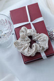 arge silver sequin scrunchie, the perfect accessory for adding a touch of luxury and sparkle to any festive outfit. Handmade with care, its oversized design creates a voluminous, glamorous effect, making it ideal for dressing up your hair for Christmas dinners, New Year’s Eve celebrations, or any special occasion.