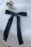 Add a touch of timeless elegance and sophistication to any occasion with our Blue Velvet Hair Bow withFrench Barrette. Measuring a striking 6 inches wide by 10 inches long, this luxurious hair bow is a perfect statement piece for weddings, parties, and festive celebrations. Crafted from rich, navy blue velvet fabric it exudes classic glamour while enhancing any hairstyle.