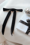 Add a touch of timeless elegance and sophistication to any occasion with our Black Velvet Hair Bow with Pearls. Measuring a striking 6 inches wide by 10 inches long, this luxurious hair bow is a perfect statement piece for weddings, parties, and festive celebrations. Crafted from rich, black velvet fabric and adorned with delicately placed pearls, it exudes classic glamour while enhancing any hairstyle.