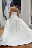 Basque waist satin wedding dress with pockets and train. Beautiful elegant satin bridal dress for the elegant and modern bride. Basque waist is the trendiest wedding dress style in the upcoming season. 