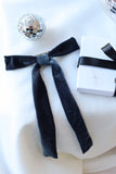 Add a touch of timeless elegance and sophistication to any occasion with our Blue Velvet Hair Bow withFrench Barrette. Measuring a striking 6 inches wide by 10 inches long, this luxurious hair bow is a perfect statement piece for weddings, parties, and festive celebrations. Crafted from rich, navy blue velvet fabric it exudes classic glamour while enhancing any hairstyle.