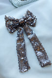 Add a touch of elegance and sparkle to any special occasion with our Luxury Sequin Hair Bow. Measuring a striking 6 inches wide by 10 inches long, this dazzling bow makes a perfect statement piece for weddings, parties, and festive celebrations. Available in captivating purple, classic black, and shimmering silver sequined fabric, it complements any outfit beautifully. Each bow is intricately adorned with high-quality sequins that catch the light, creating a radiant effect to elevate your look.